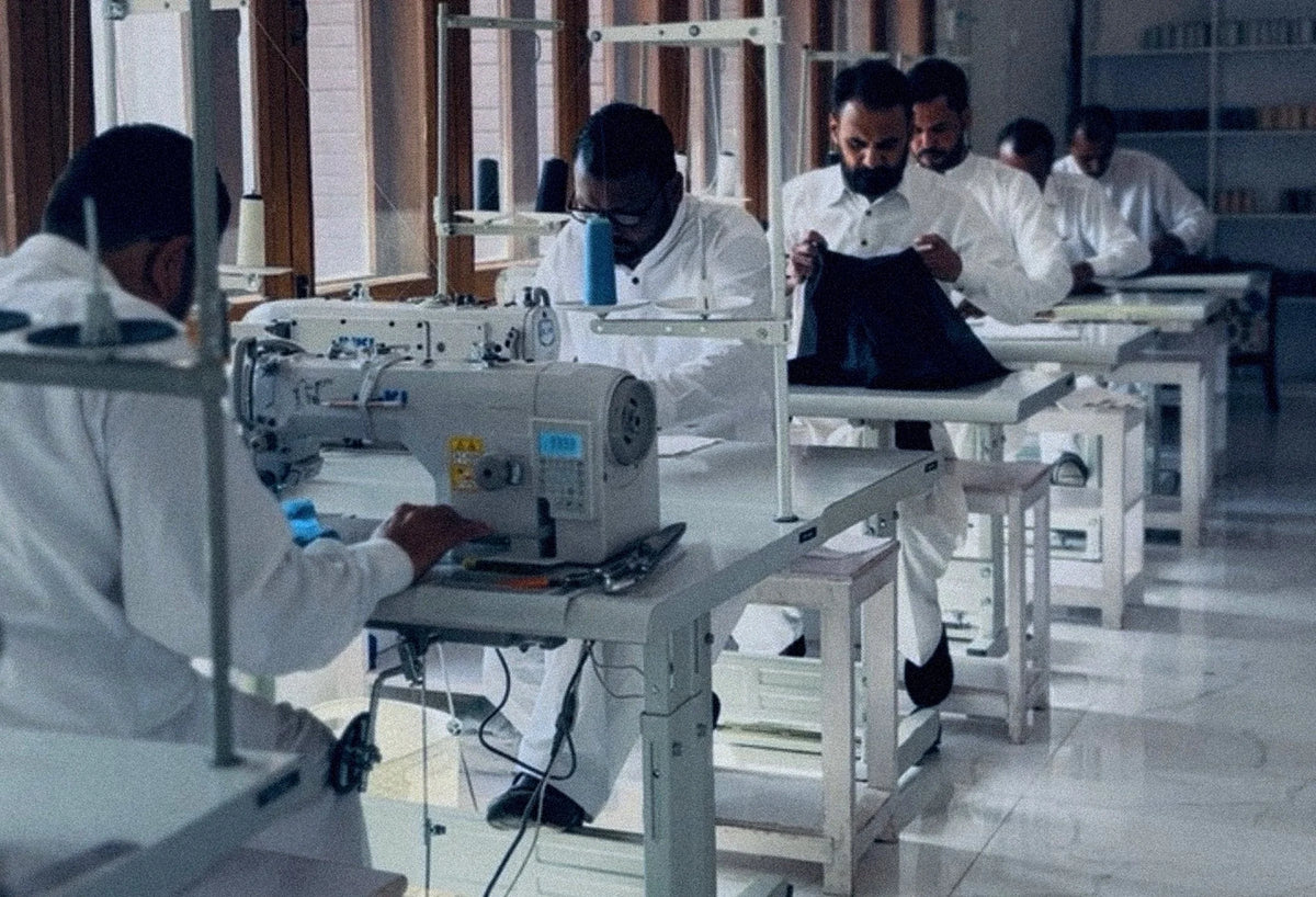 The sewing floor at Zero Waste Studio, makers at their machines in a white room.