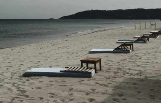 The empty beach at Pampelonne out of season, loungers in a line along pale sand.