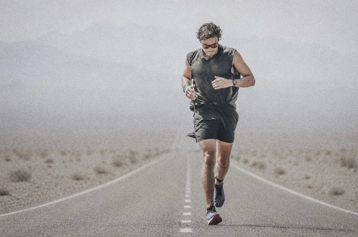 A runner on a straight desert road in hard heat, Chubut, Argentina.