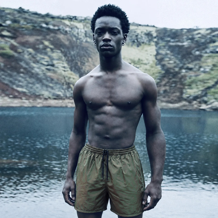 OxMoon Active Swim Shorts by a crater lake